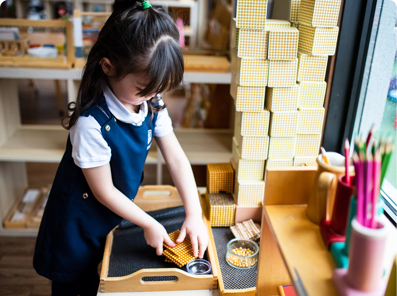 Child playing with building blocks indoors.