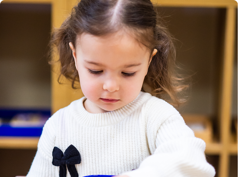 Young girl focused on an activity.